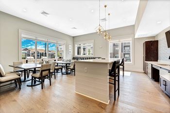 Resident lounge with kitchen, dining space and fireplace